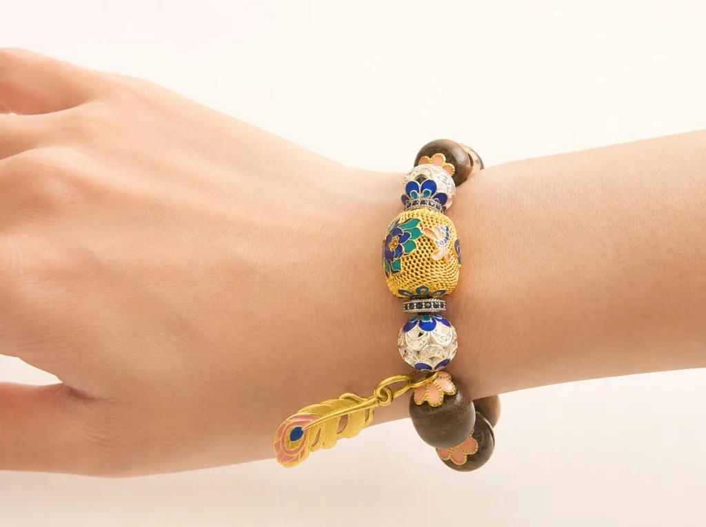 Kynam agarwood and cloisonné bracelet worn on the wrist