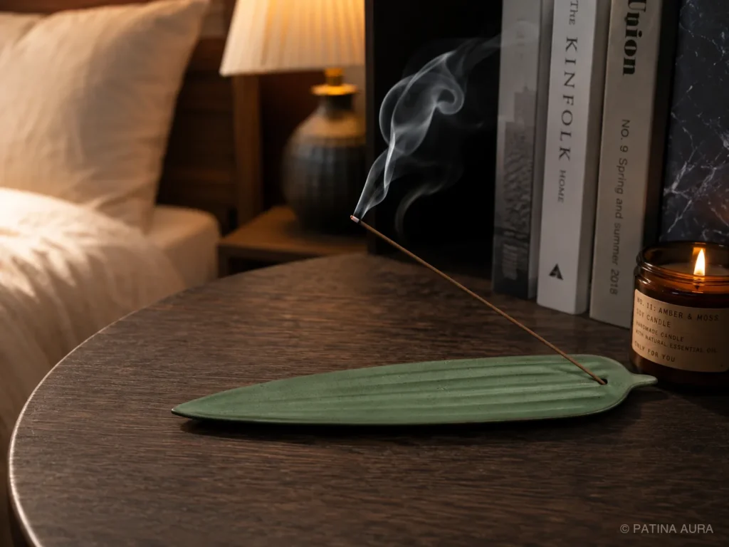 Agarwood incense burning beside a bed before sleep